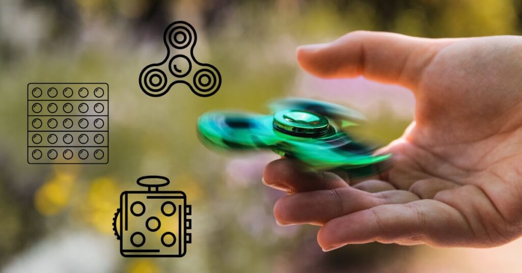 A close-up of a hand spinning a fidget spinner. Other doodles of stim toys are overlaid on the photo.