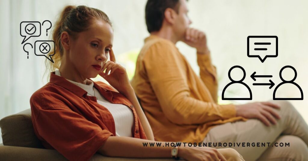 A couple sit side by side on a sofa, turned away from each other and actively avoiding communication. Neurodivergent communication in relationships.